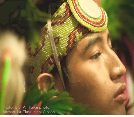 Native youth wearing beaded headdress